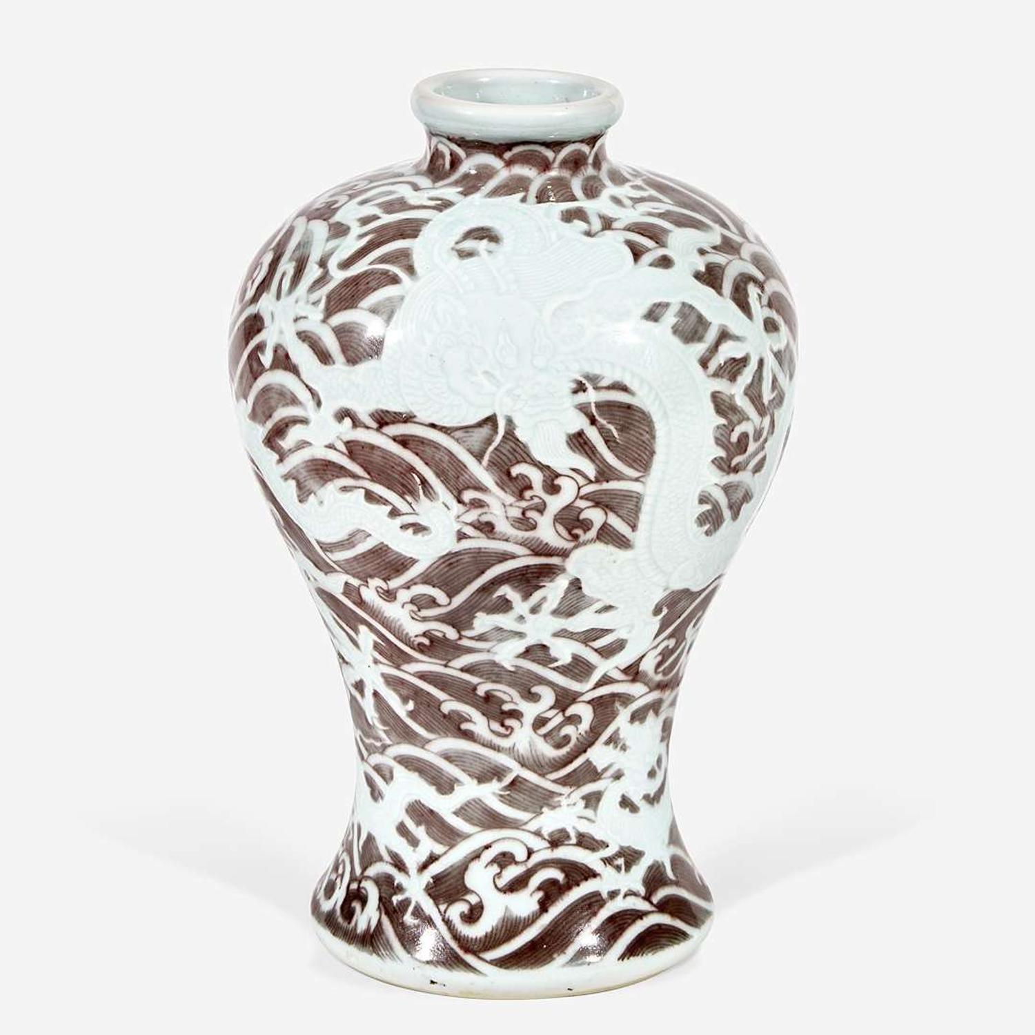 A Chinese carved and underglaze red "Dragons and Waves" vase, Meiping Yongzheng six-character mark and of the period