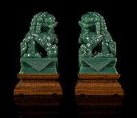 A Pair of Chinese Green Jade Figures of Fu Lions Height 6 1/4 inches. — 20TH CENTURY