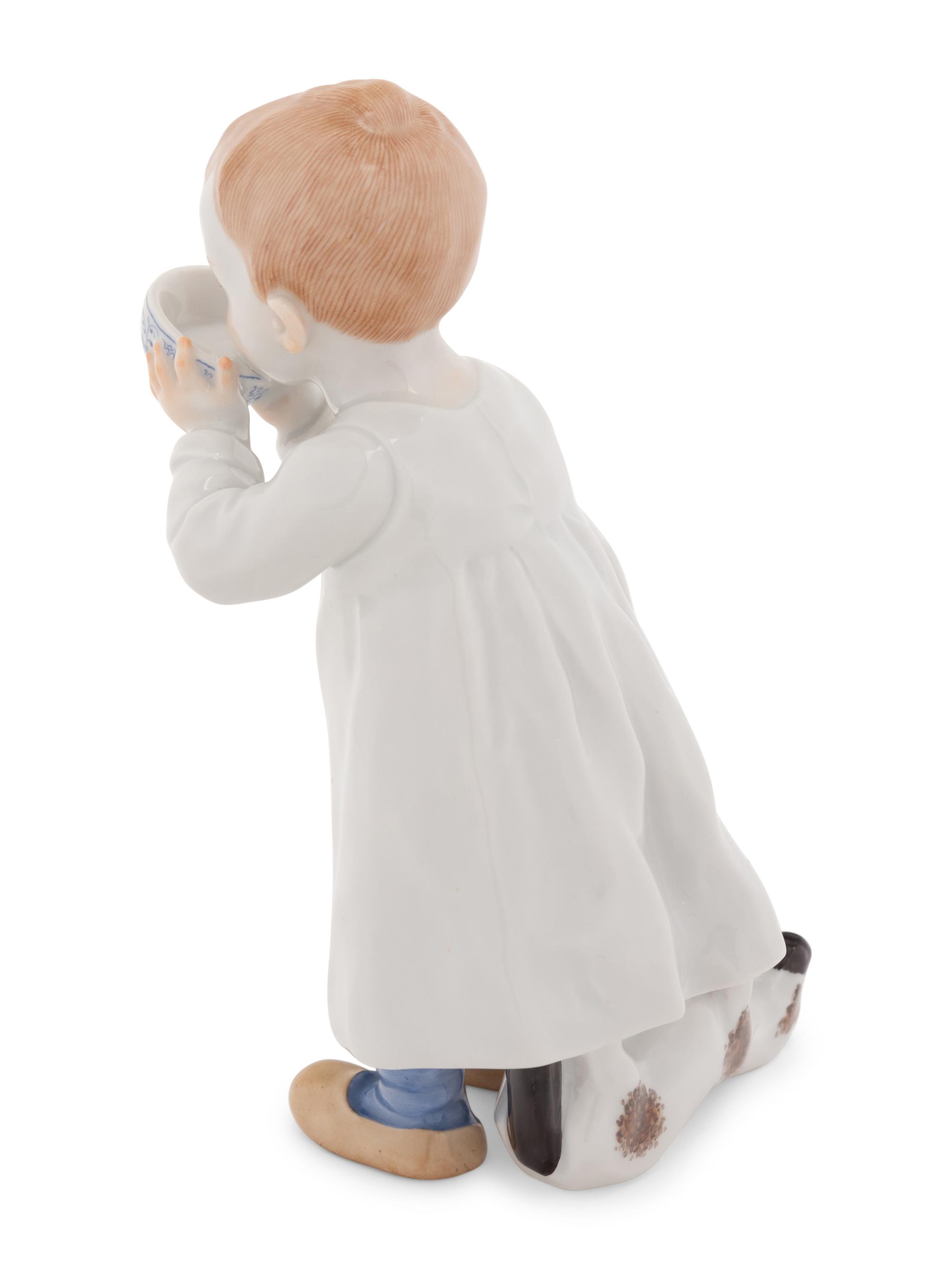 A Meissen Porcelain Figure of a Boy Drinking From a Blue Onion Bowl