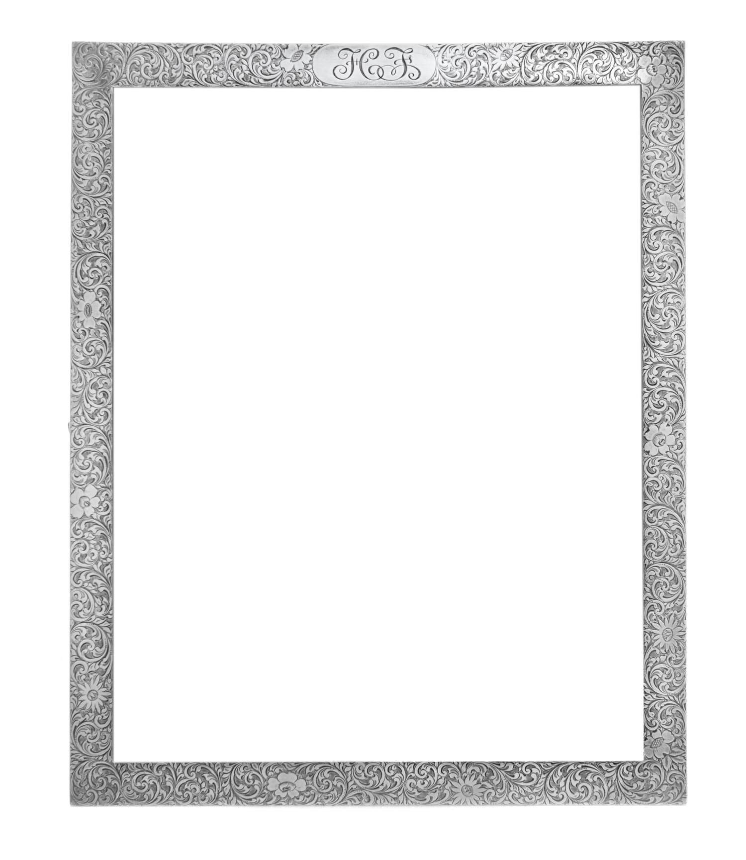 An American Silver Picture Frame, Tiffany & Co., New York, NY, having allover foliate volute and floral decoration, the top centered wi