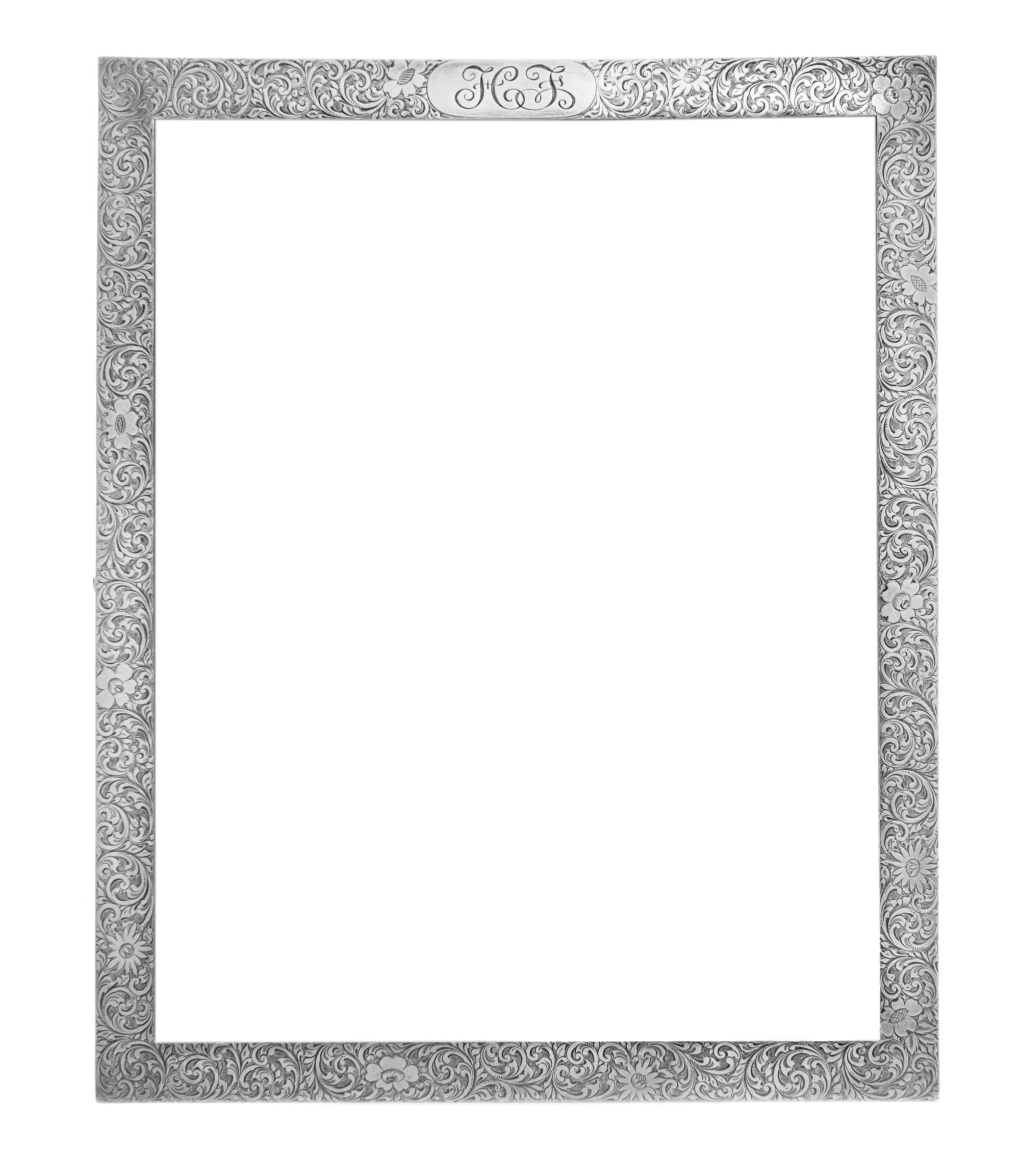 An American Silver Picture Frame, Tiffany & Co., New York, NY, having allover foliate volute and floral decoration, the top centered wi