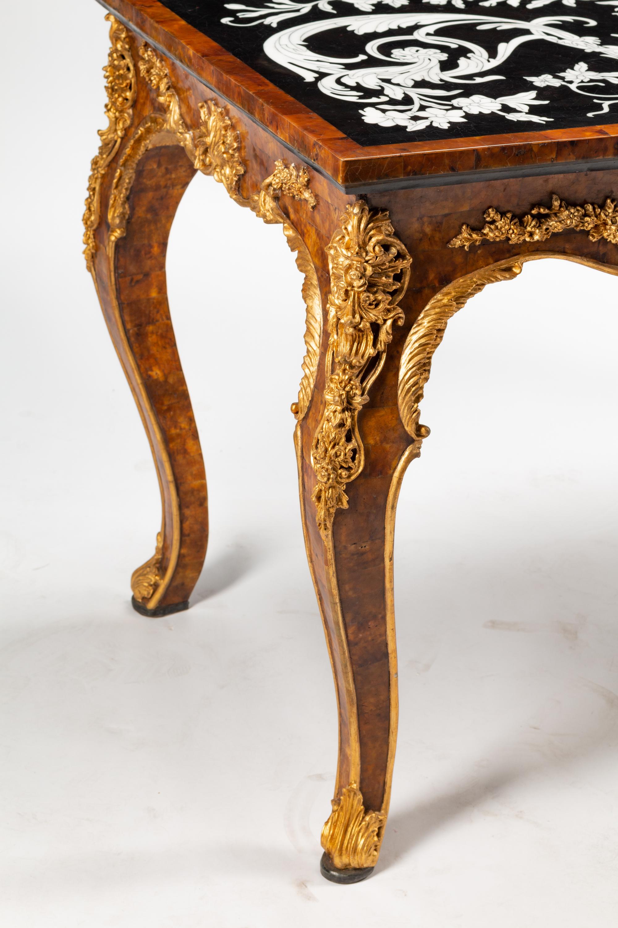 An Italian Baroque Style Parcel Gilt Shell and Marble-Veneered Table