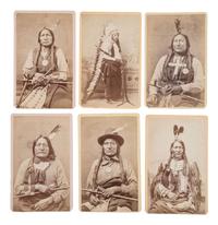 MITCHELL, Daniel S. (1838-1929), photographer. A group of 24 CDVs of Sioux chiefs and warriors at Red Cloud Agency. Cheyenne, WY, ca 1877.