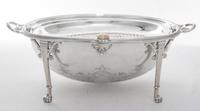 A Silver-plate Bacon Warmer, , of ovoid form with a rotating lid and raised on four monoped feet.