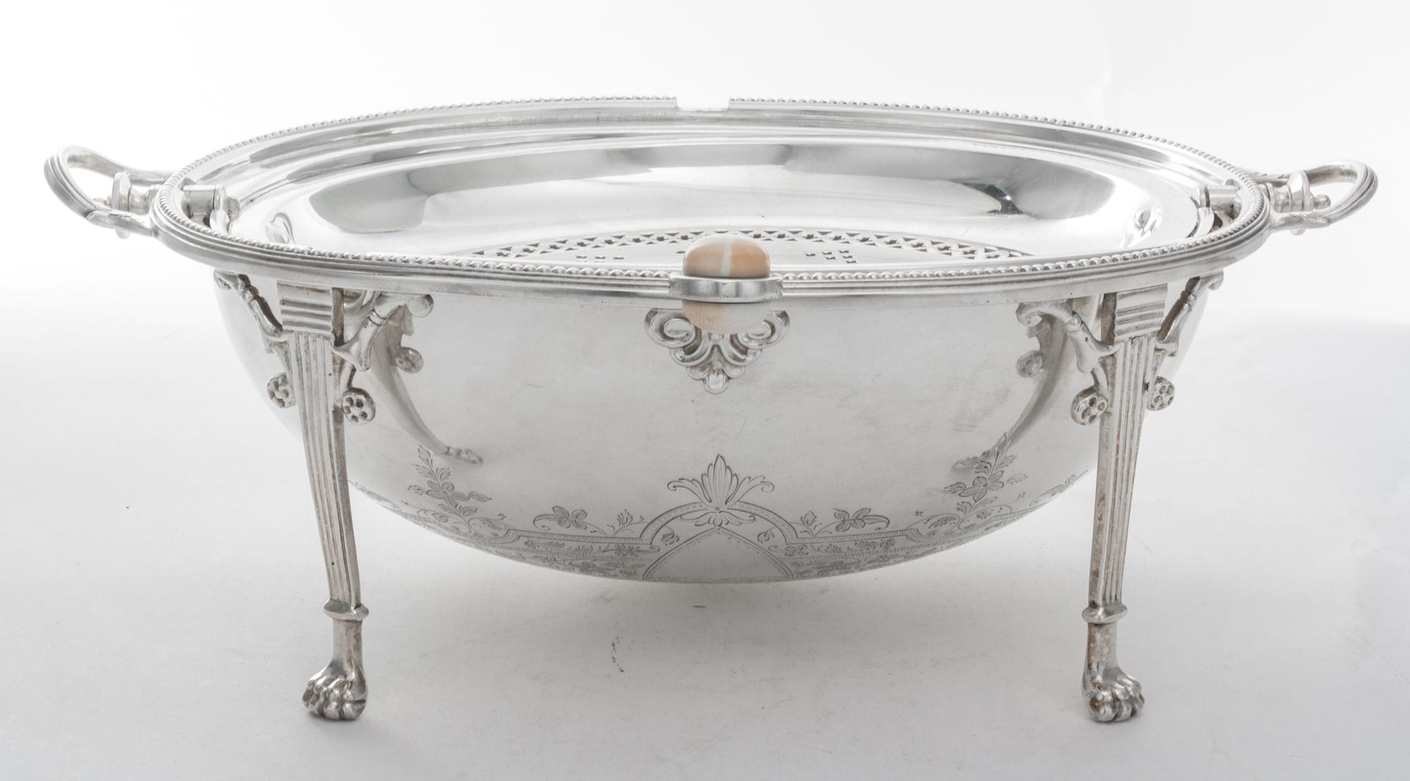A Silver-plate Bacon Warmer, , of ovoid form with a rotating lid and raised on four monoped feet.