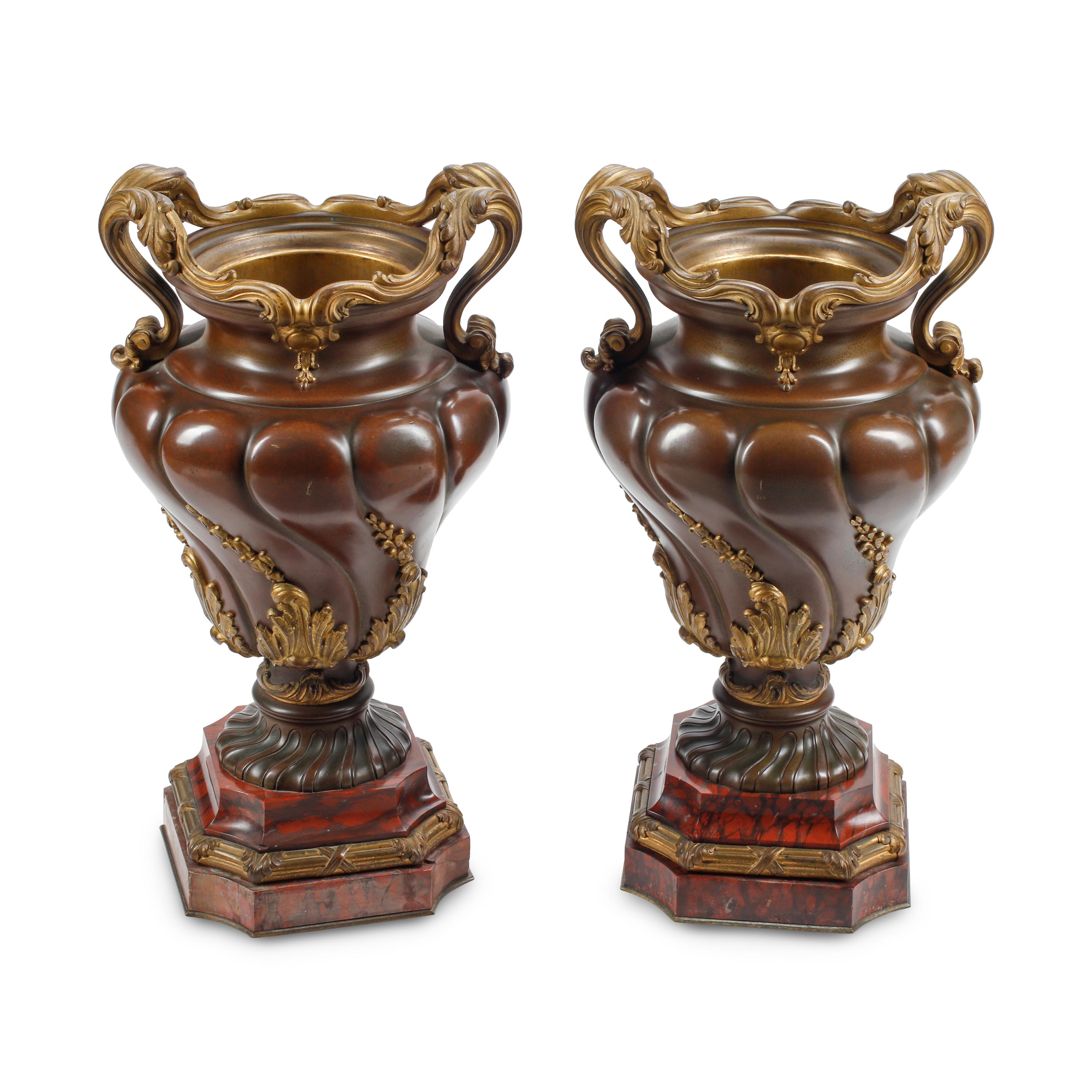 A Pair of French Patinated and Parcel Gilt Bronze Urns