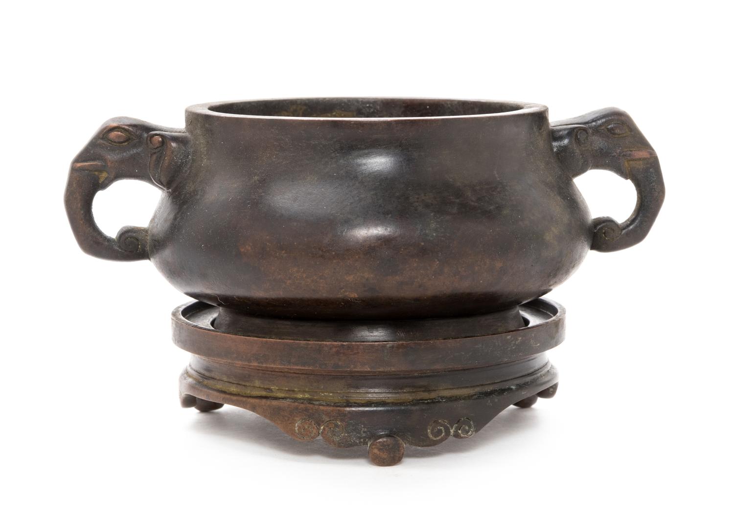 A Chinese Bronze Tripod Elephant Handled Censer Diameter 12 inches. — 20TH CENTURY