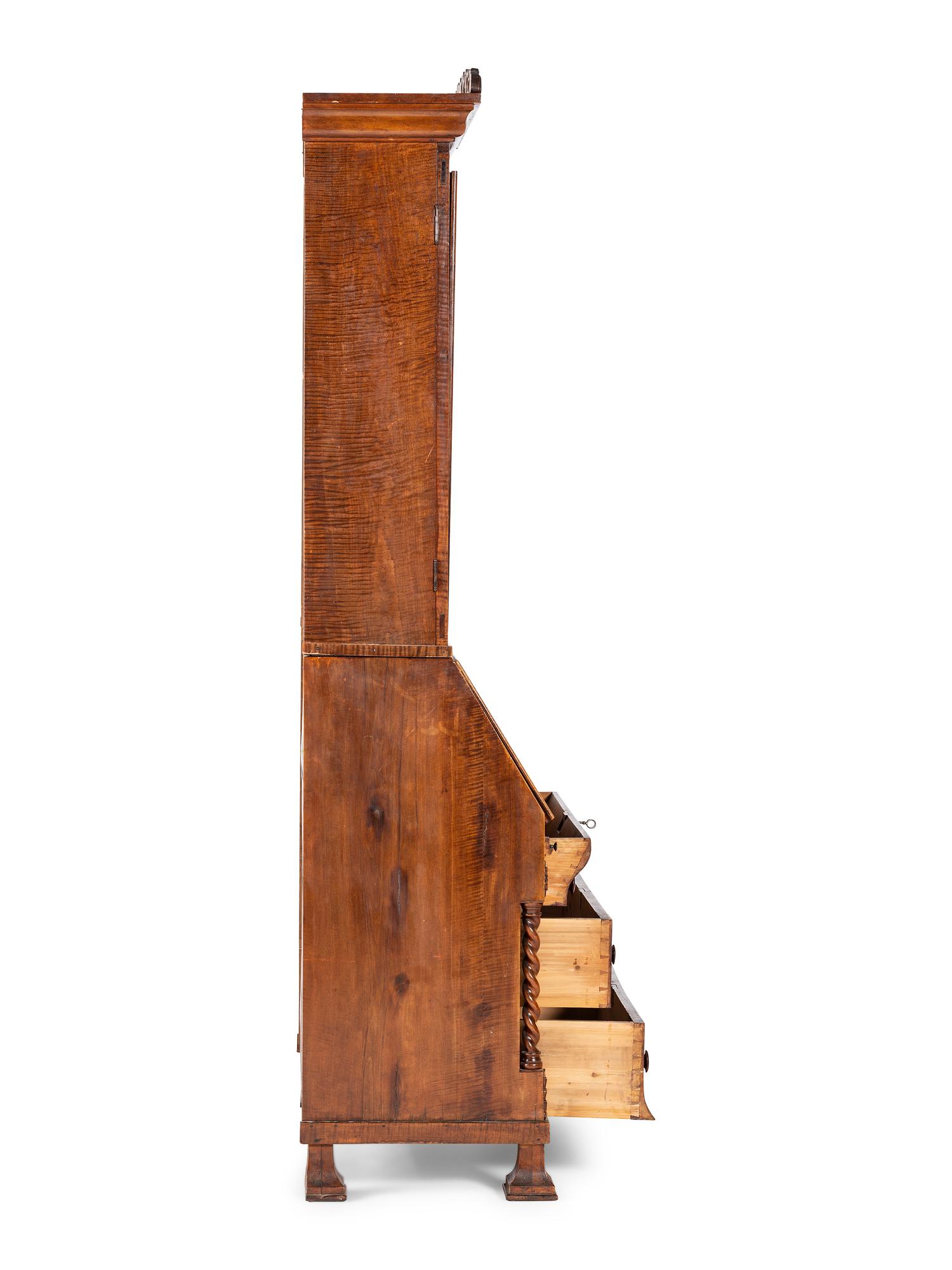 A Classical Style Carved and Highly Figured Tiger Maple Slant Front Desk