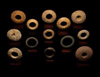 Thirteen Saharan Stone Bracelets and Discoidals