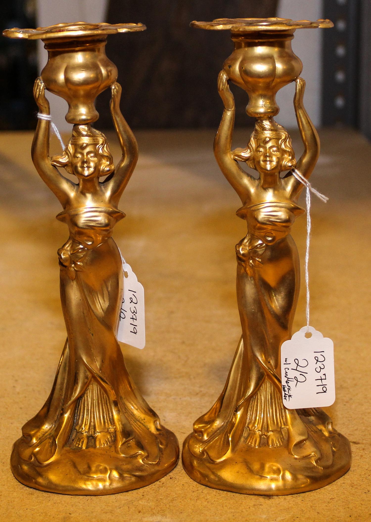 A Pair of Figural Candlesticks. Height 9 inches.