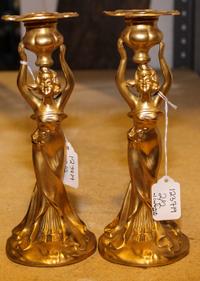 A Pair of Figural Candlesticks. Height 9 inches.