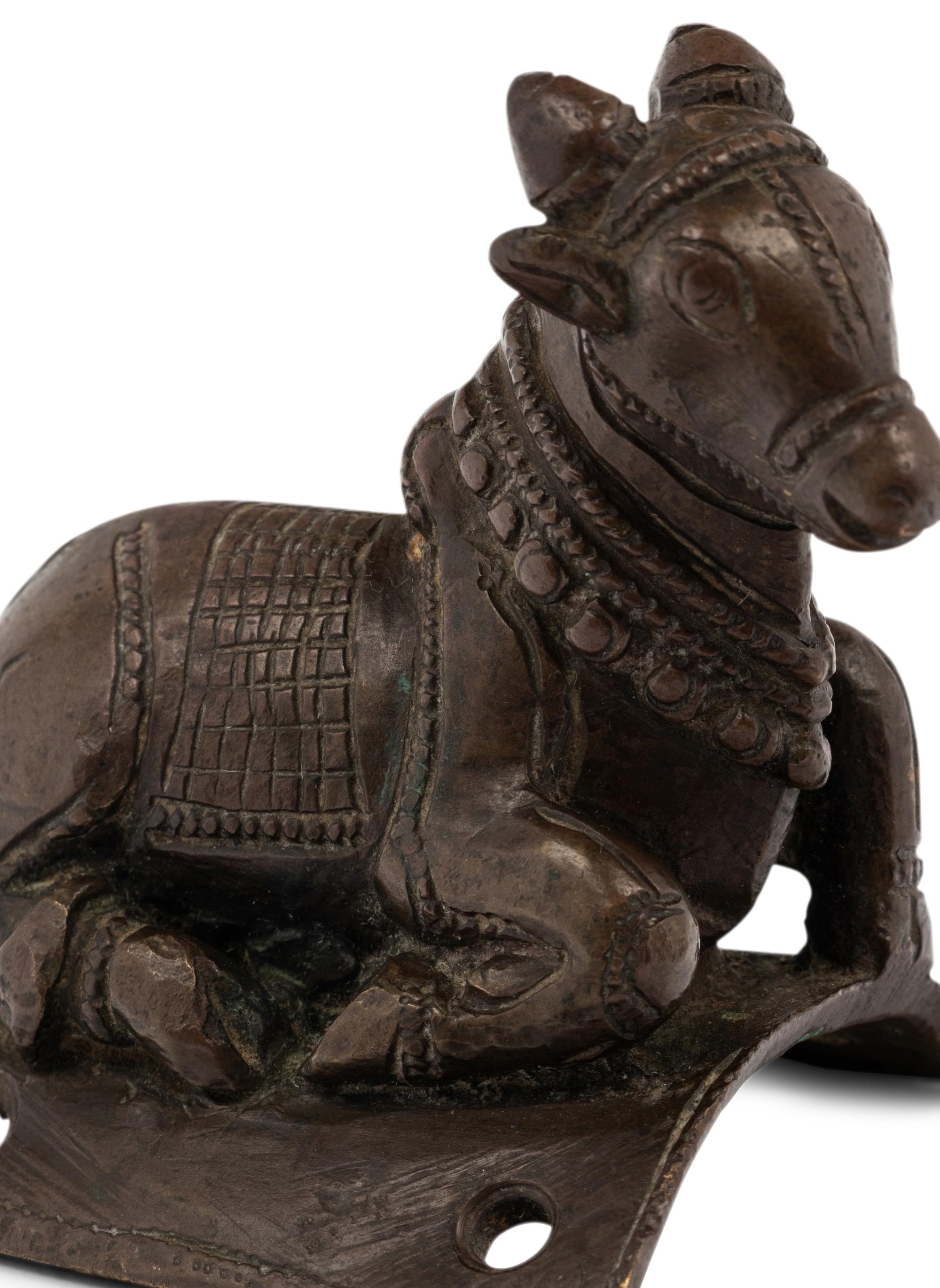 A Small Indian Bronze Figure of a Recumbent Bull
