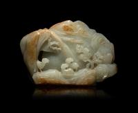 A Chinese Carved Russet and Pale Celadon Jade Boulder