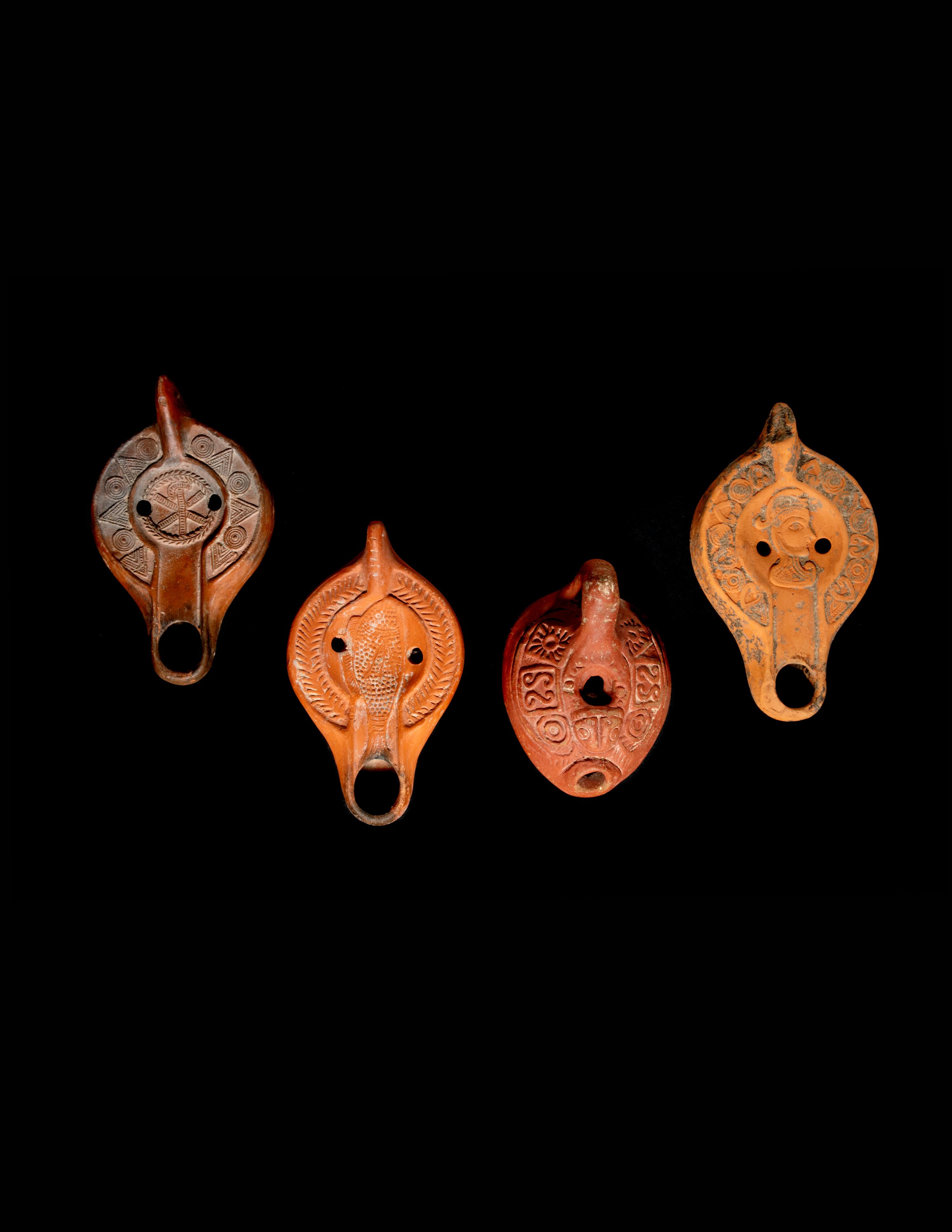 Four Roman Molded Terra Cotta Oil Lamps