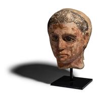 An Egyptian Painted Limestone Head of a Youth