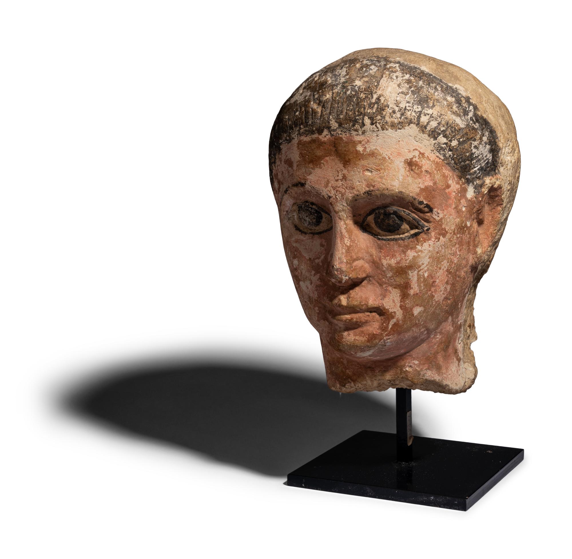 An Egyptian Painted Limestone Head of a Youth