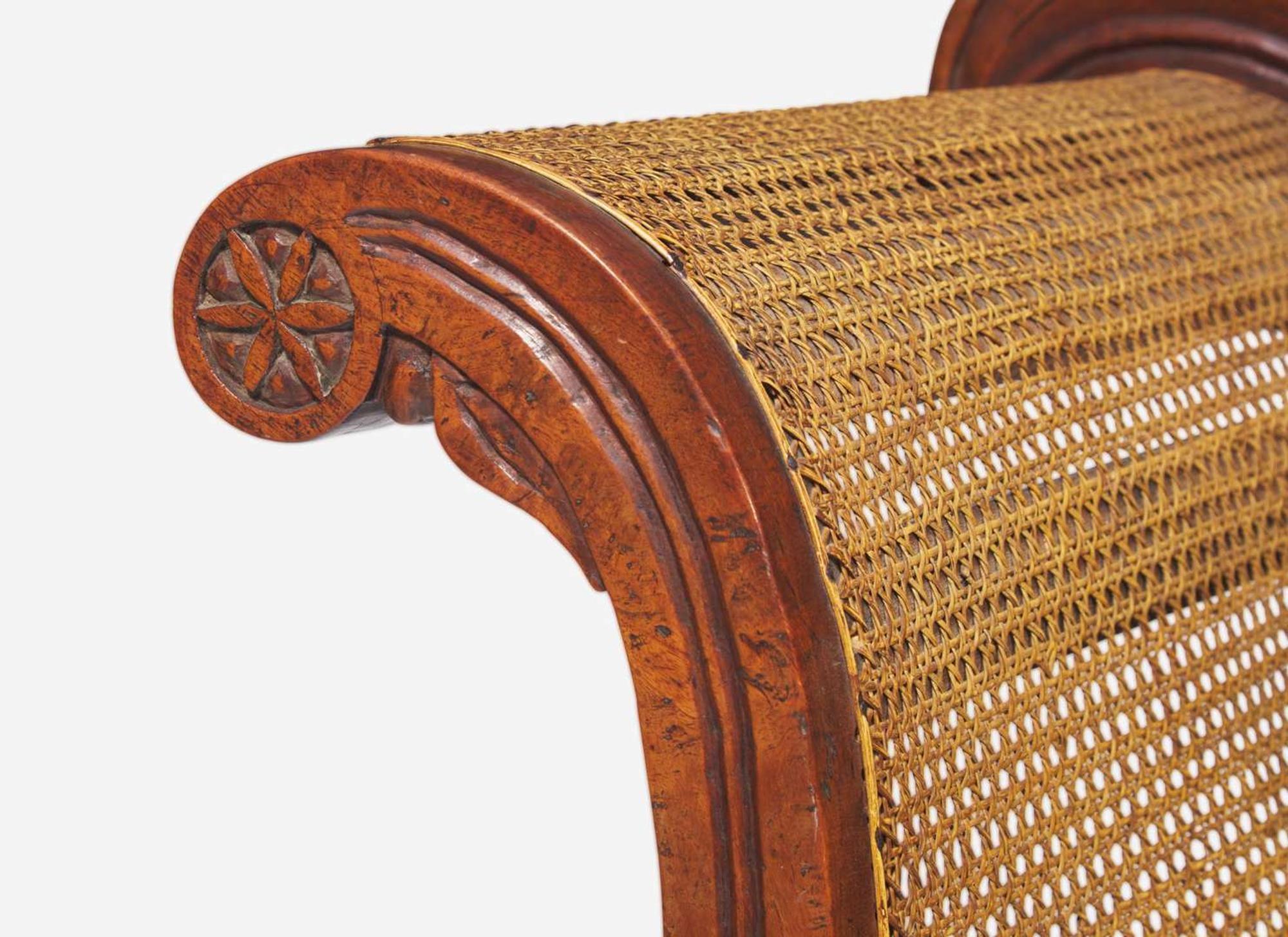 An Anglo-Colonial carved hardwood and caned sofa, first half 19th century