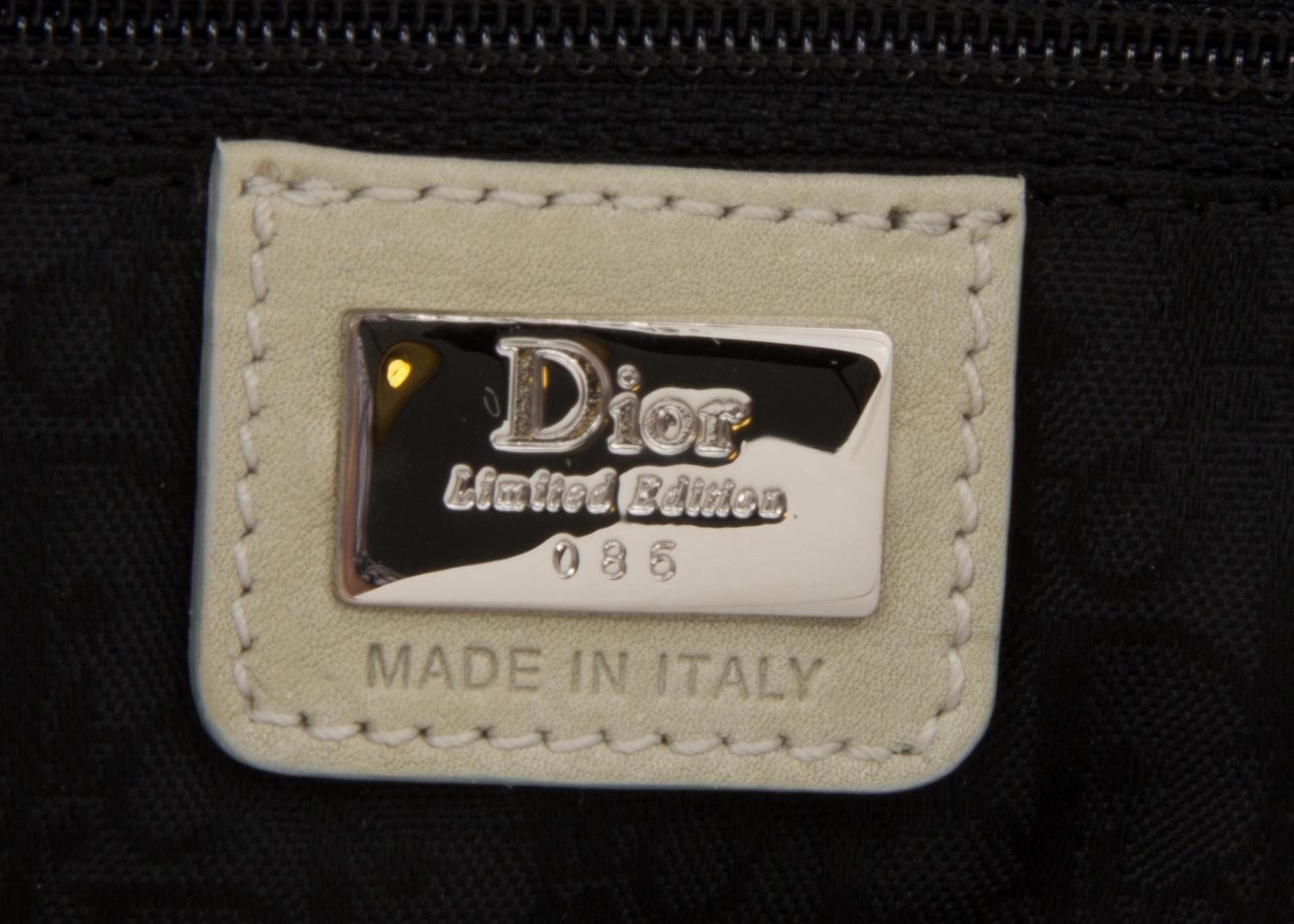 A Christian Dior Cream Denim Saddle Handbag, 10" x 8" x 2.25".