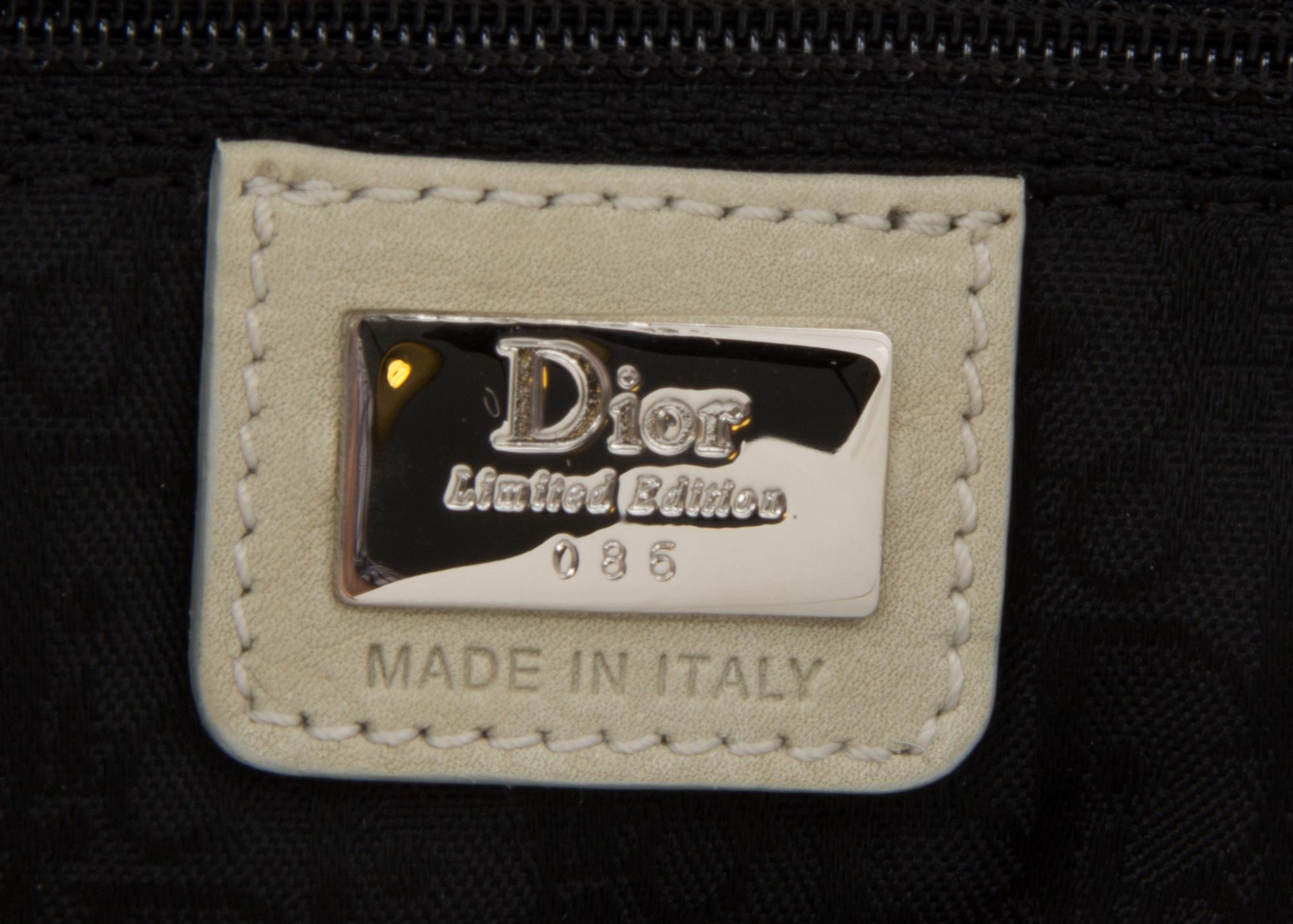 A Christian Dior Cream Denim Saddle Handbag, 10" x 8" x 2.25".