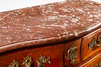A Régence Style Gilt Bronze Mounted Kingwood Marble-Top Commode