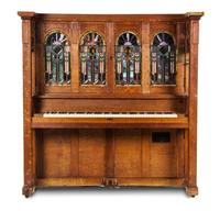 A Marquette Cremona Style K Oak and Stained Glass Orchestrion, CIRCA 1915, SERIAL NO. 11527, Height 66 x width 64 1/2 x depth 31 1/4 in — CIRCA 1915, SERIAL NO. 11527,