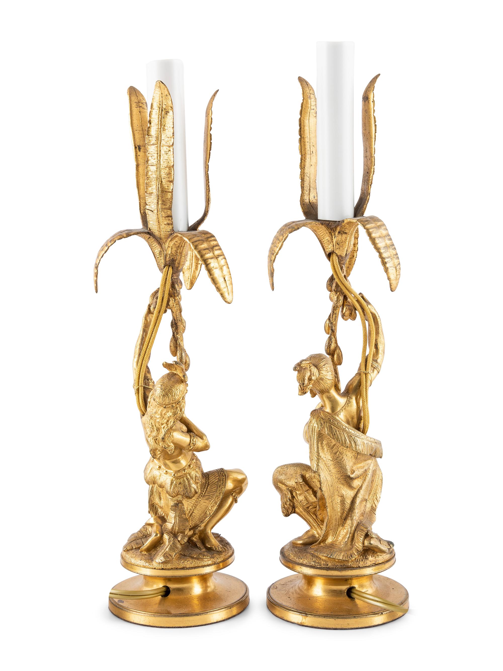 A Pair of Figural Gilt Metal Candlesticks