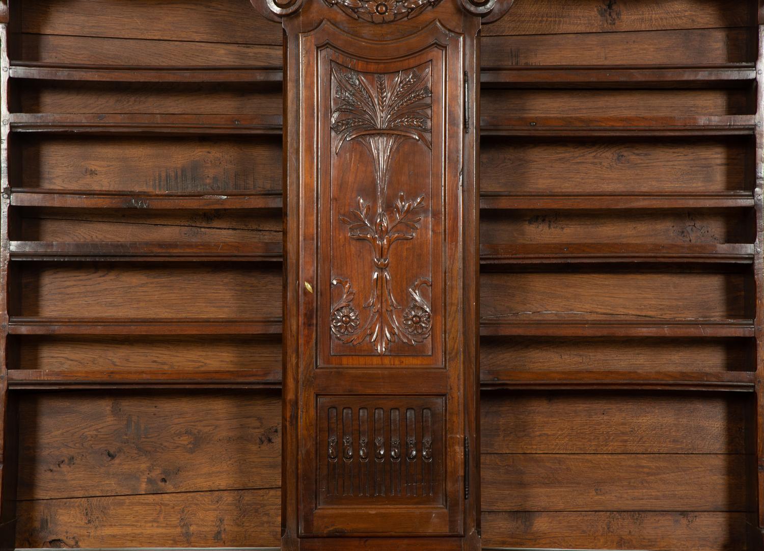 A French Provincial Carved Walnut Clock-Inset Vaissellier