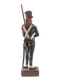 A Carved and Painted Wood Figure of a Soldier