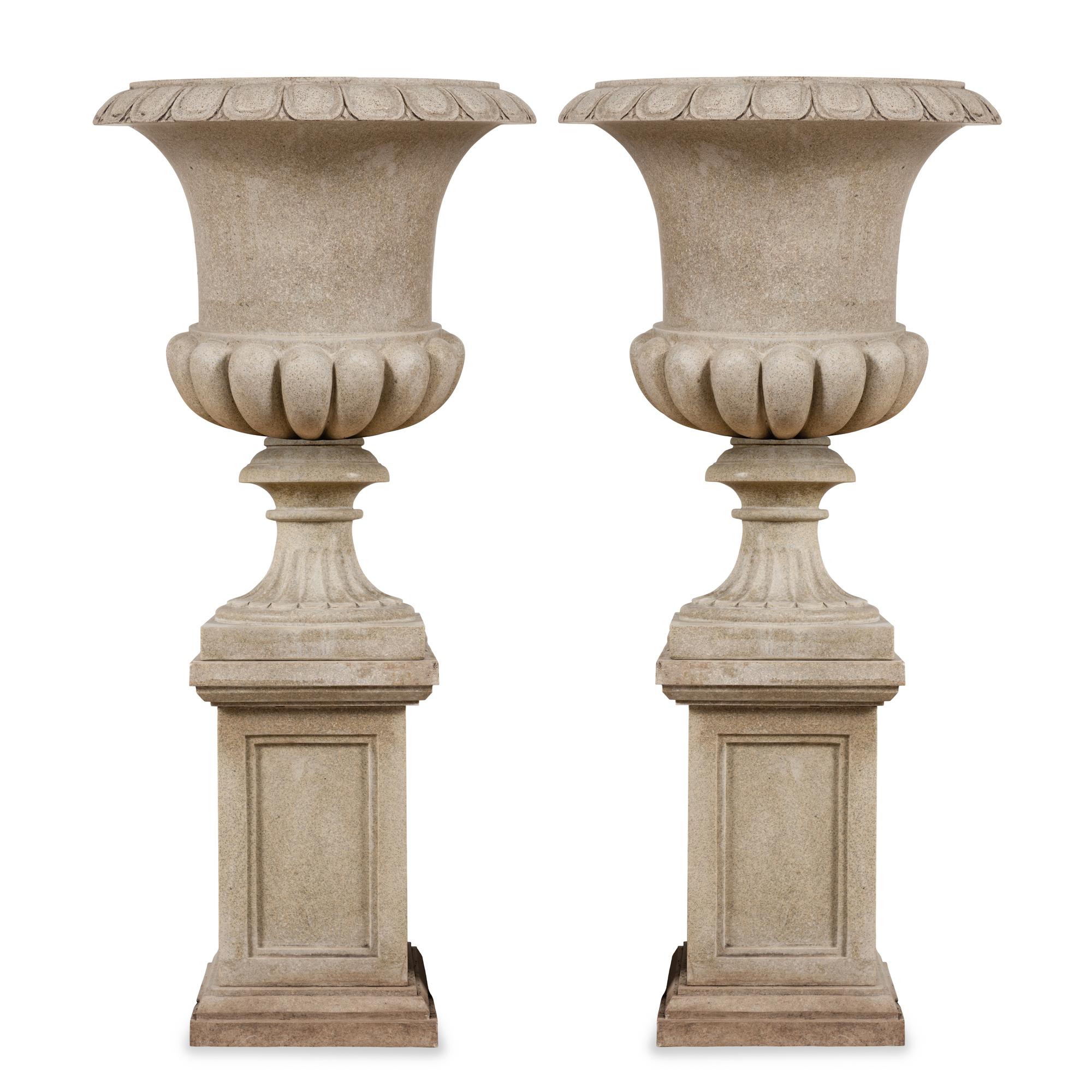 A Pair of Carved Granite Urns and Plinths