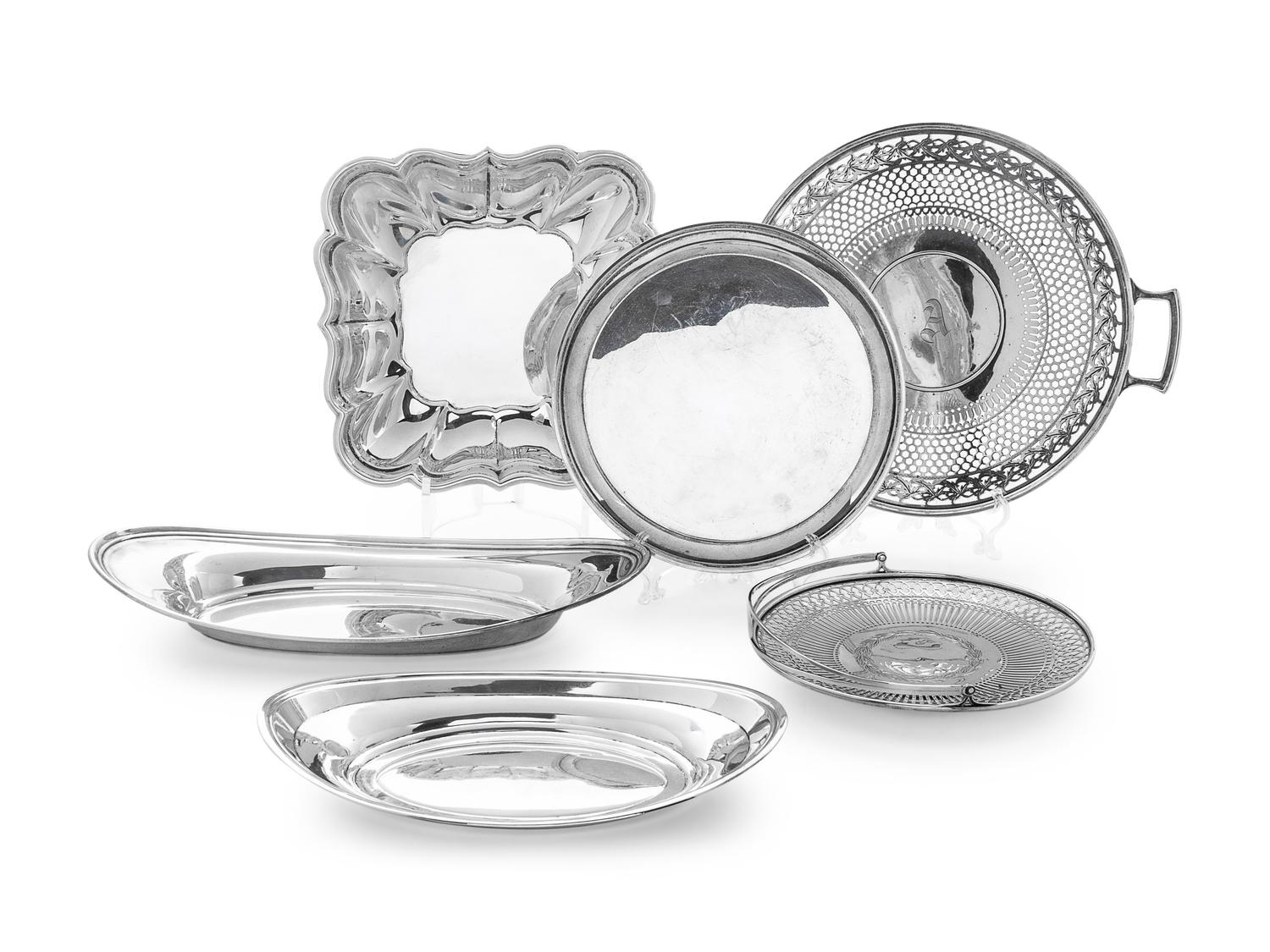 comprising two oval trays, a square platter, a pierced and handled platter, a pierced basket, and a round platter.