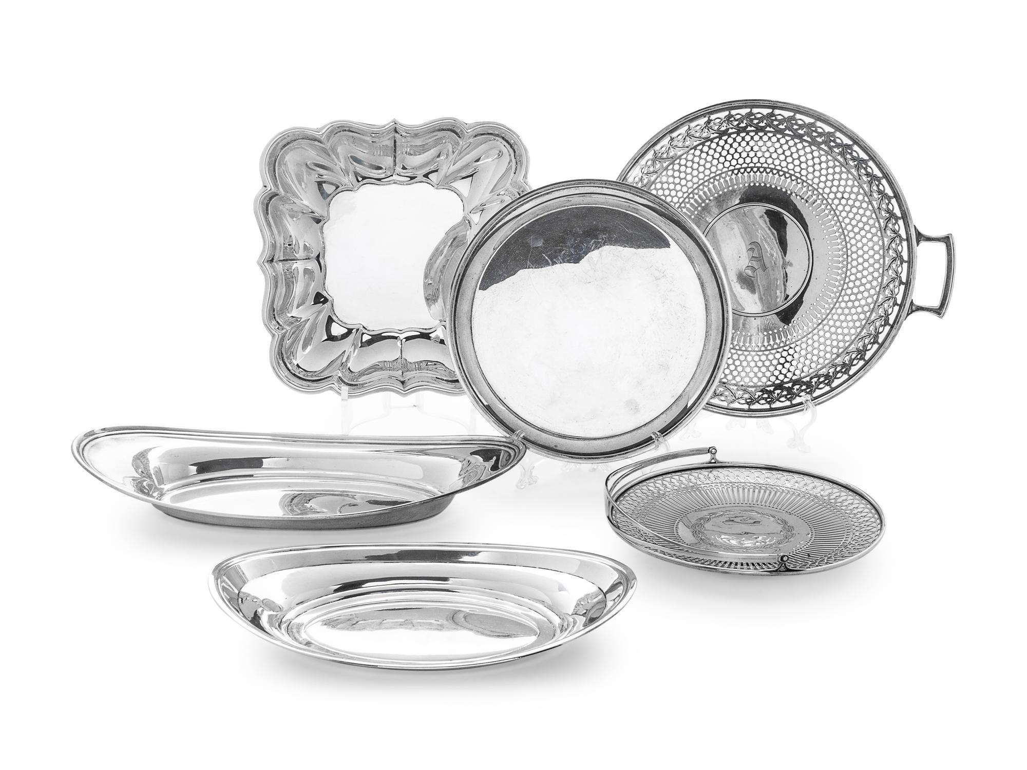 comprising two oval trays, a square platter, a pierced and handled platter, a pierced basket, and a round platter.