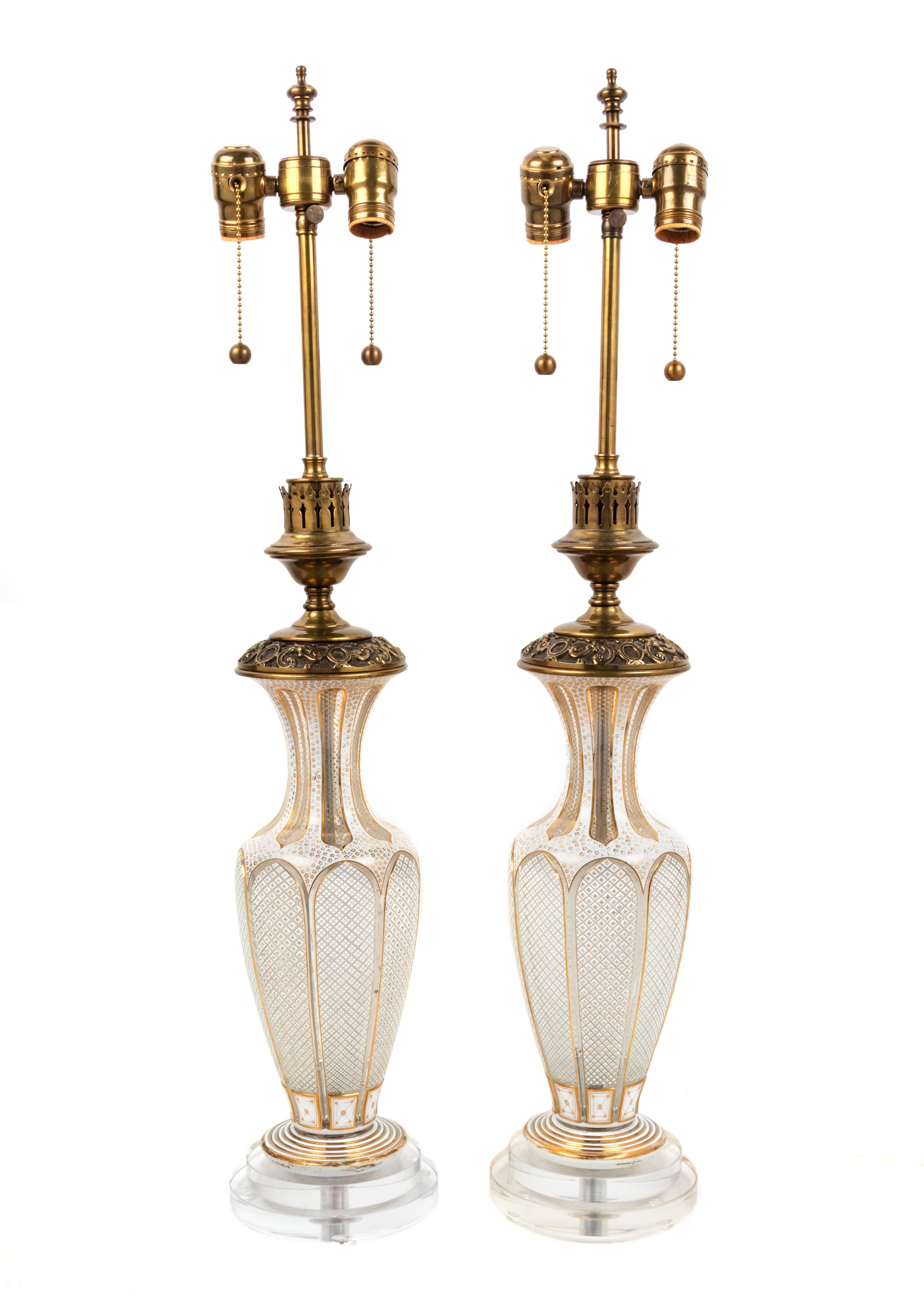 A Pair of Bohemian Parcel Gilt and Enamel Decorated Cut Glass Lamps
