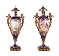 A Pair of Sèvres Style Gilt Bronze Mounted Painted and Parcel Gilt Porcelain Urns