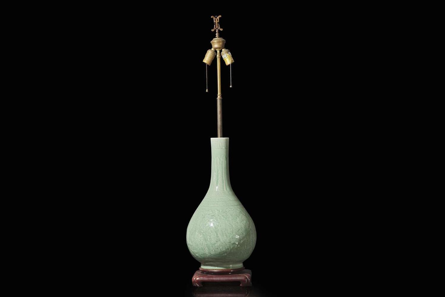 A Chinese carved celadon-glaze porcelain vase, mounted as a lamp 青釉賞瓶改製檯燈