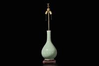 A Chinese carved celadon-glaze porcelain vase, mounted as a lamp 青釉賞瓶改製檯燈