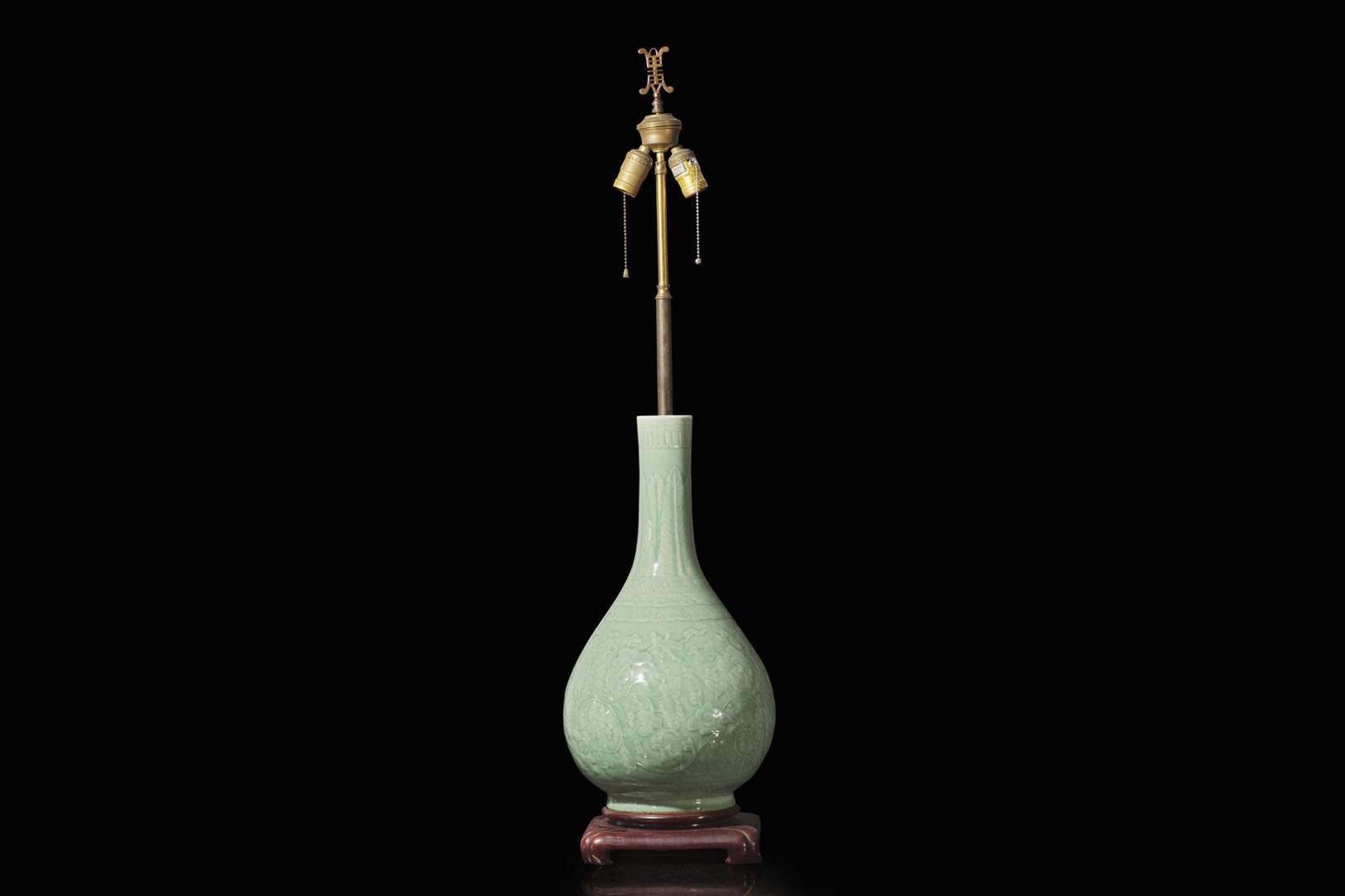 A Chinese carved celadon-glaze porcelain vase, mounted as a lamp 青釉賞瓶改製檯燈
