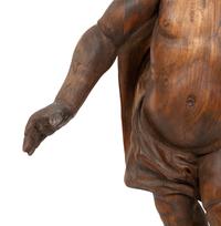 An Italian Carved Walnut Figure of Putto