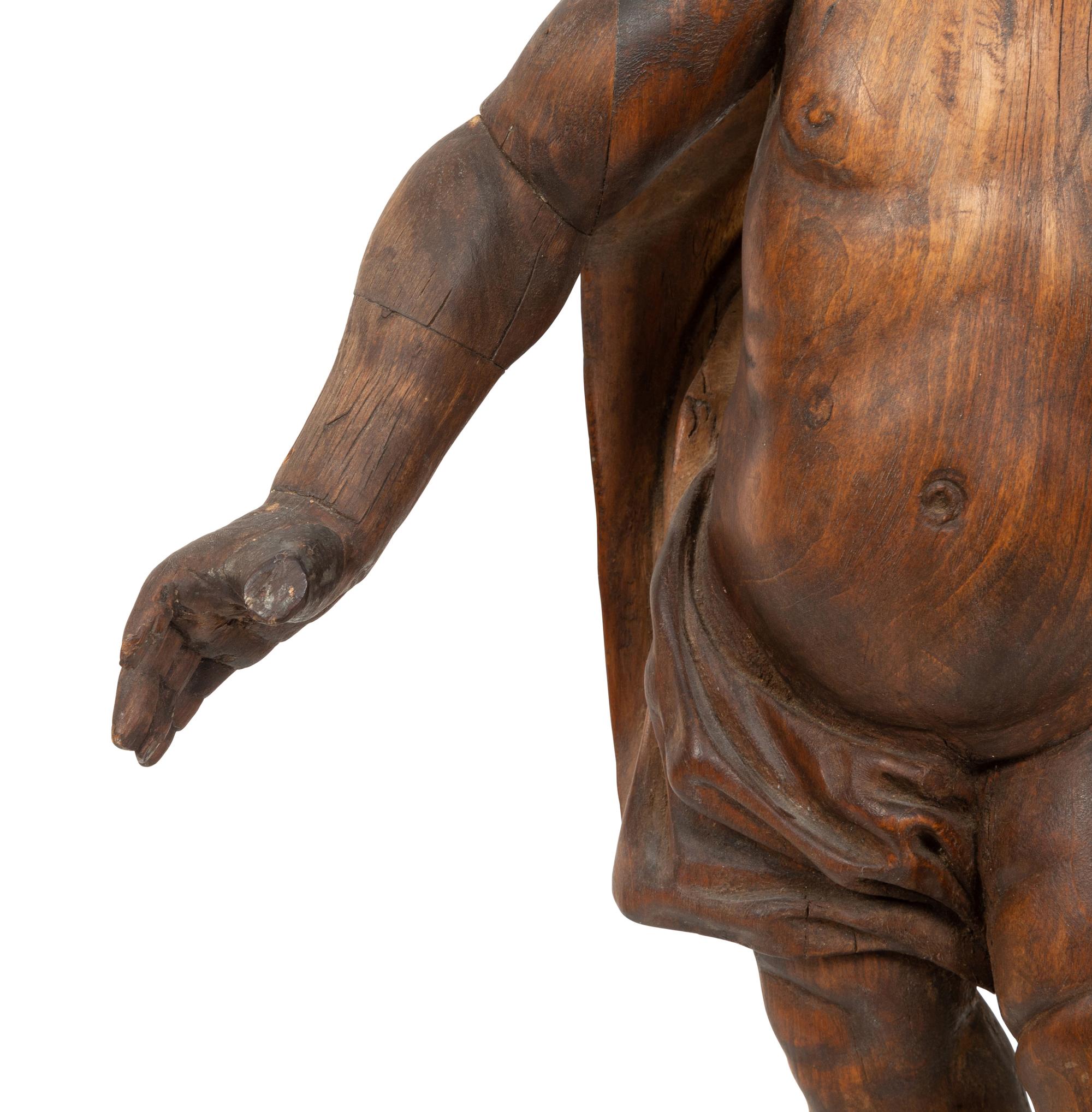 An Italian Carved Walnut Figure of Putto