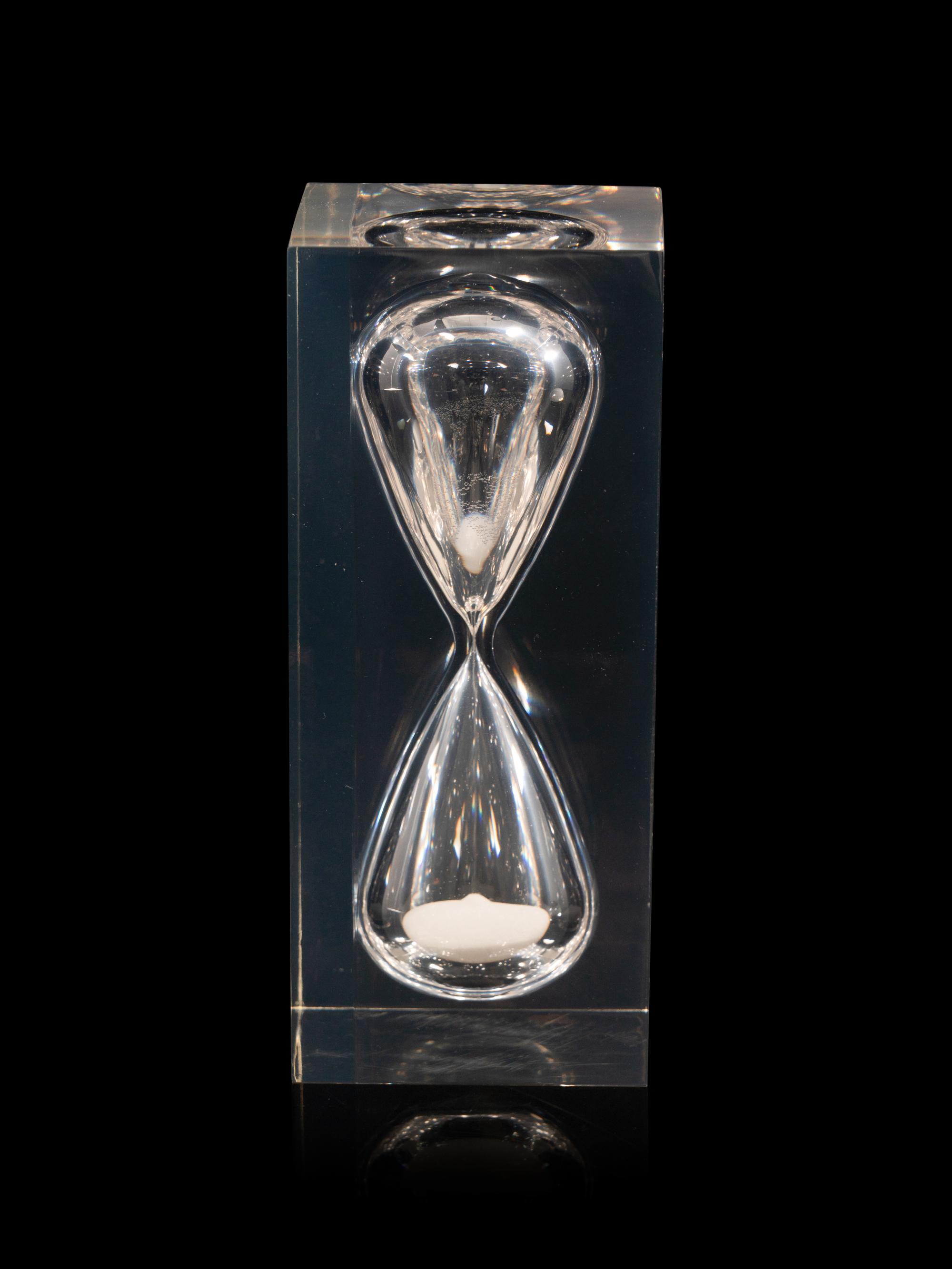 A Ralph Lauren Acrylic Clark Hourglass and a Glass Clayton Dome Paperweight