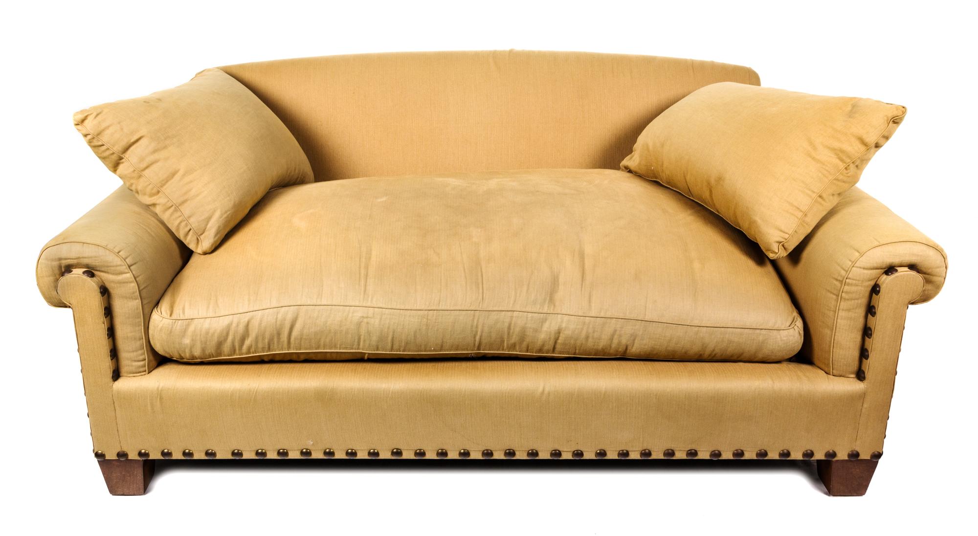 A Beige Upholstered Two-Seat Sofa Height 33 x length 76 inches.