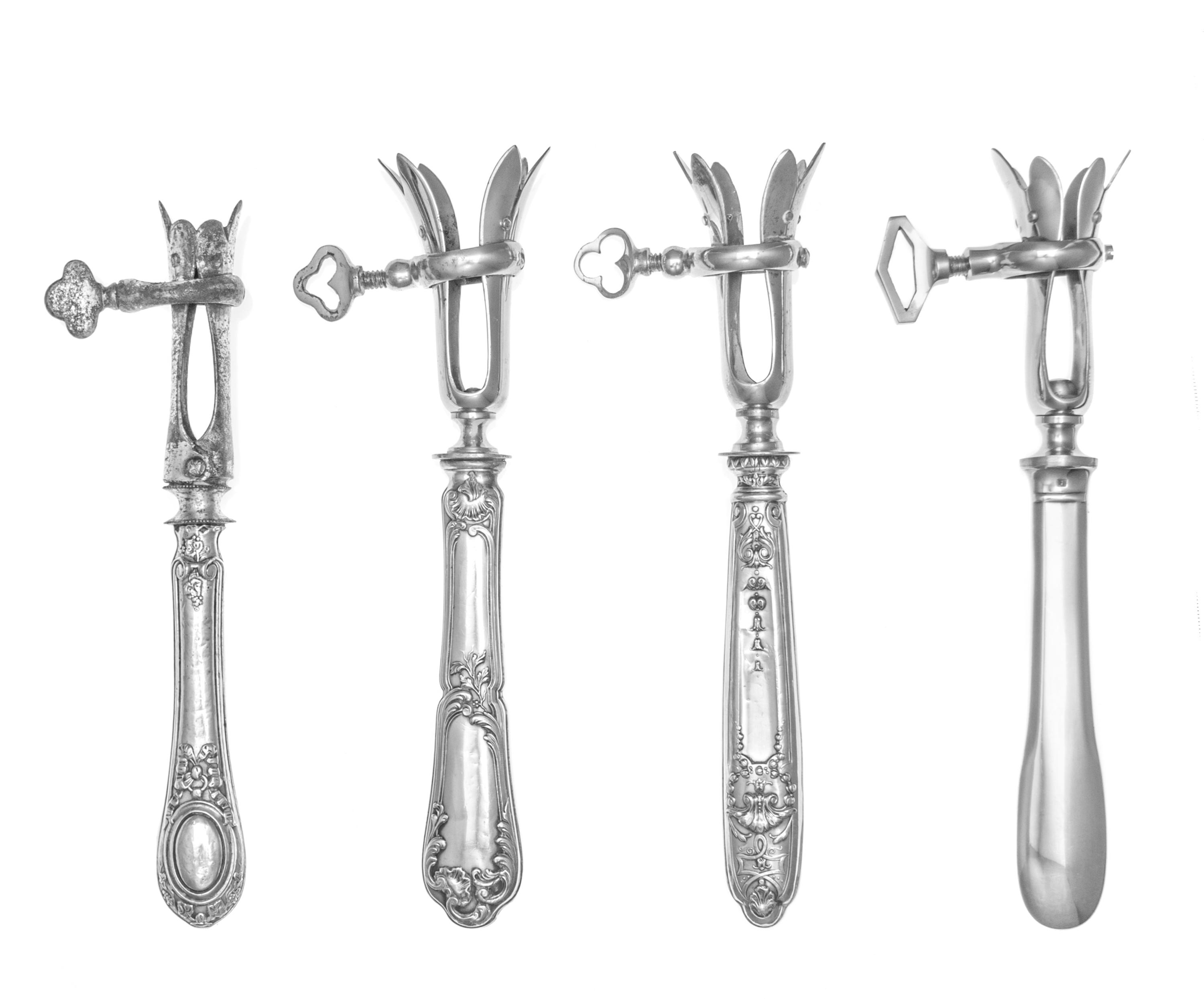 A Group of Three French Silver-Handled Bone Holders, various makers, the handles decorated with ribbon and bellflower motifs, together