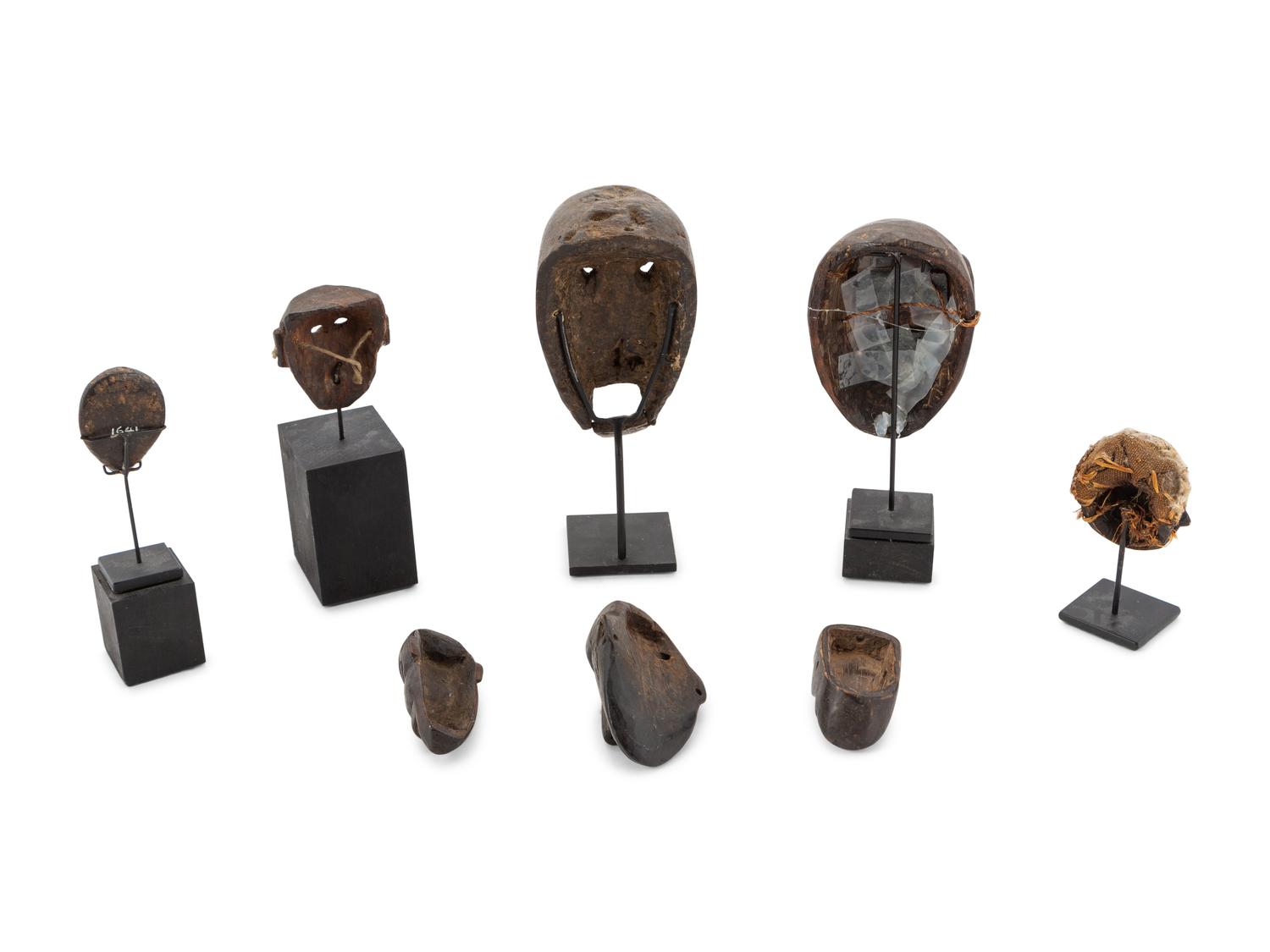 A Group of Eight Miniature Ethnographic Carved Masks