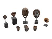 A Group of Eight Miniature Ethnographic Carved Masks