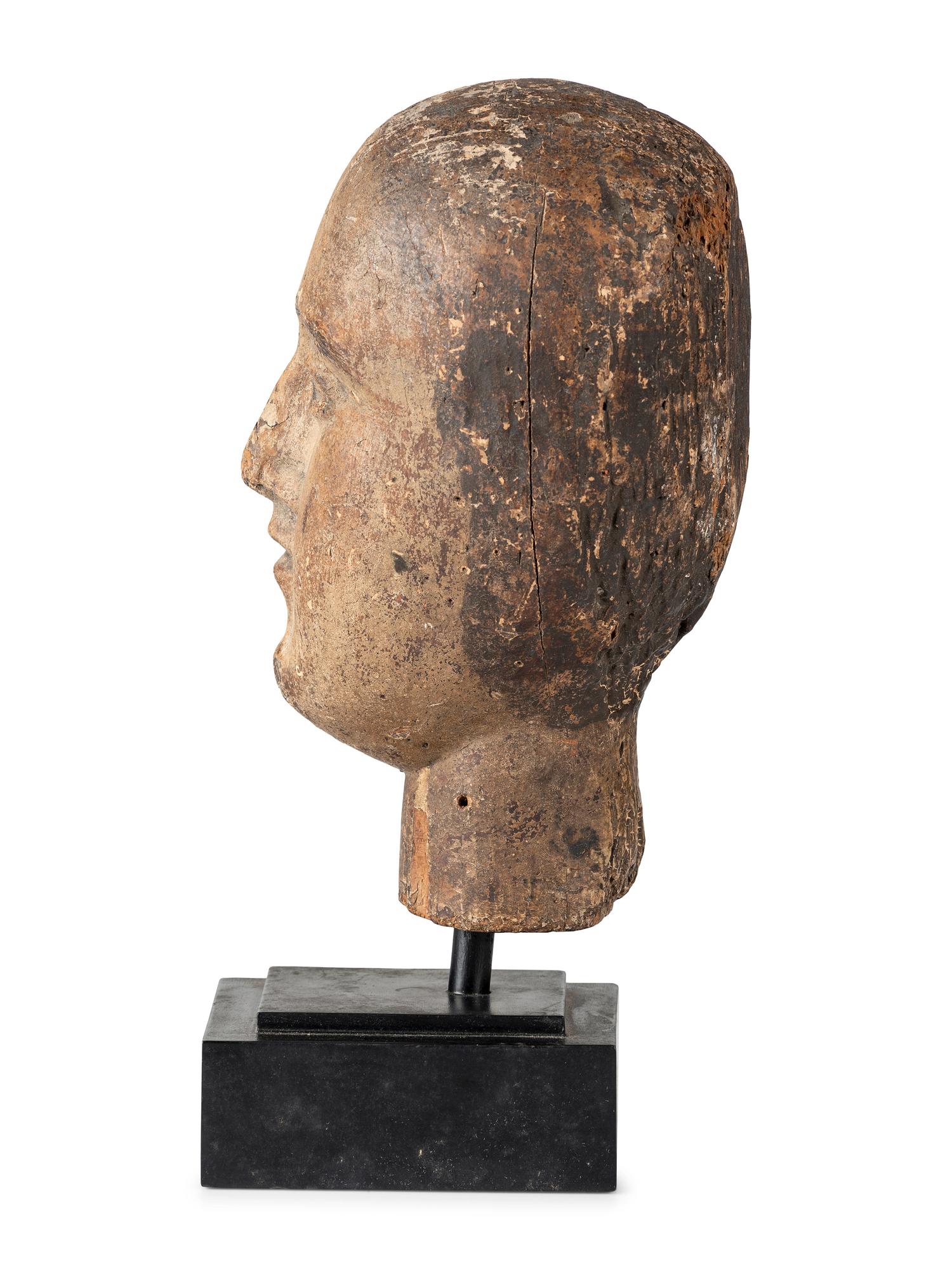 A Carved and Painted Wooden Head