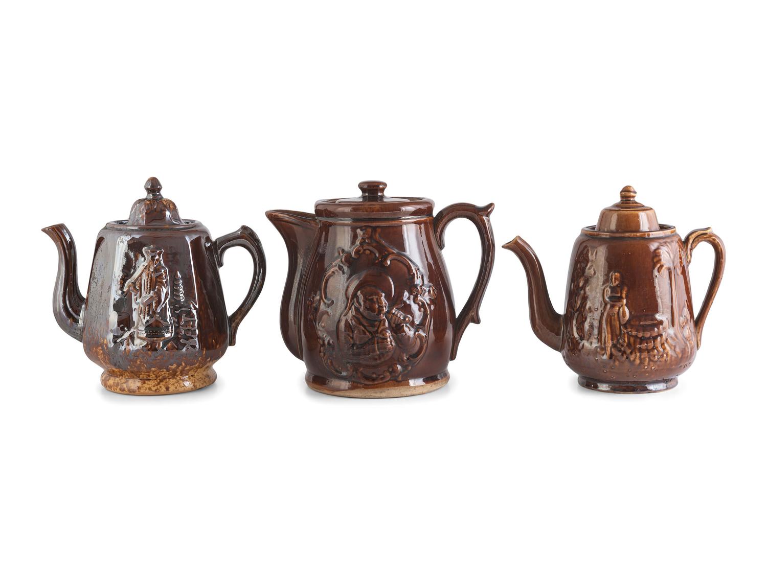 A Group of Molded Teapots and Jugs in Rockingham Glaze