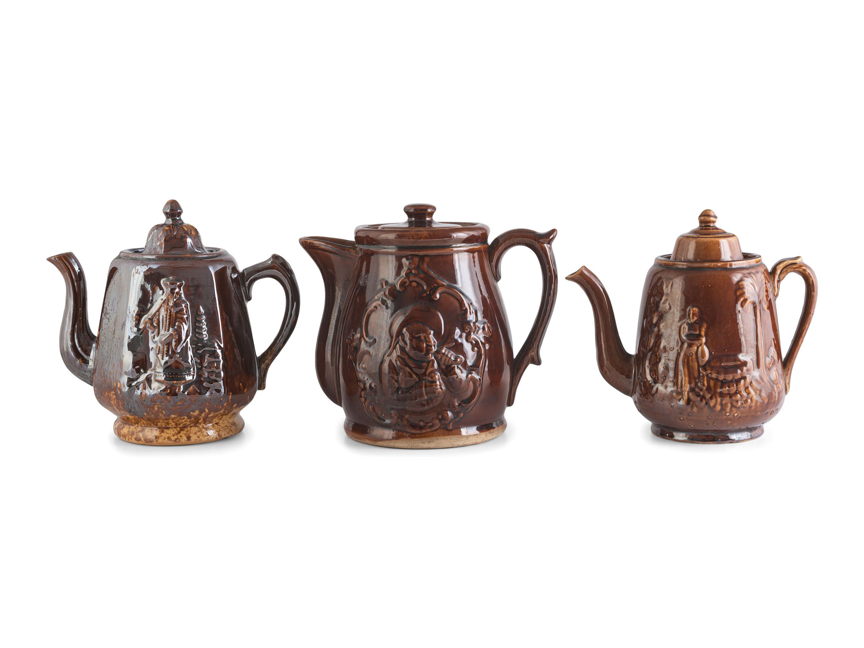 A Group of Molded Teapots and Jugs in Rockingham Glaze