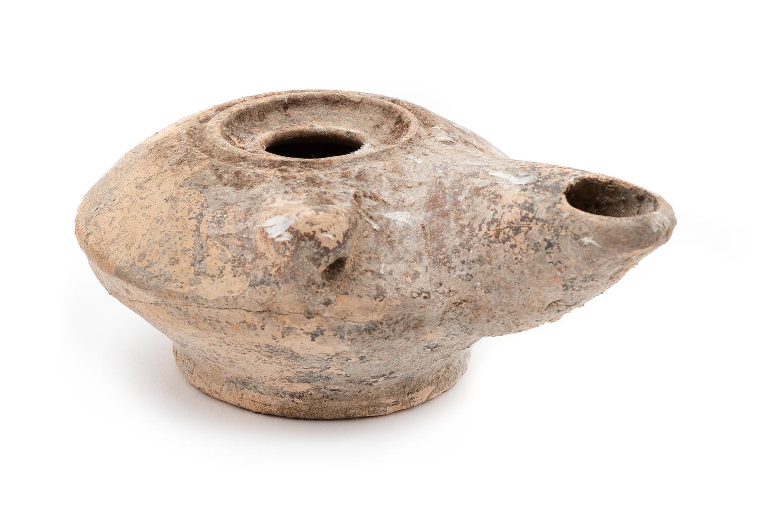 A Roman Terra Cotta Oil Lamp Height 2 x diameter 4 1/2 inches. — CIRCA 1ST-3RD CENTURY C.E.