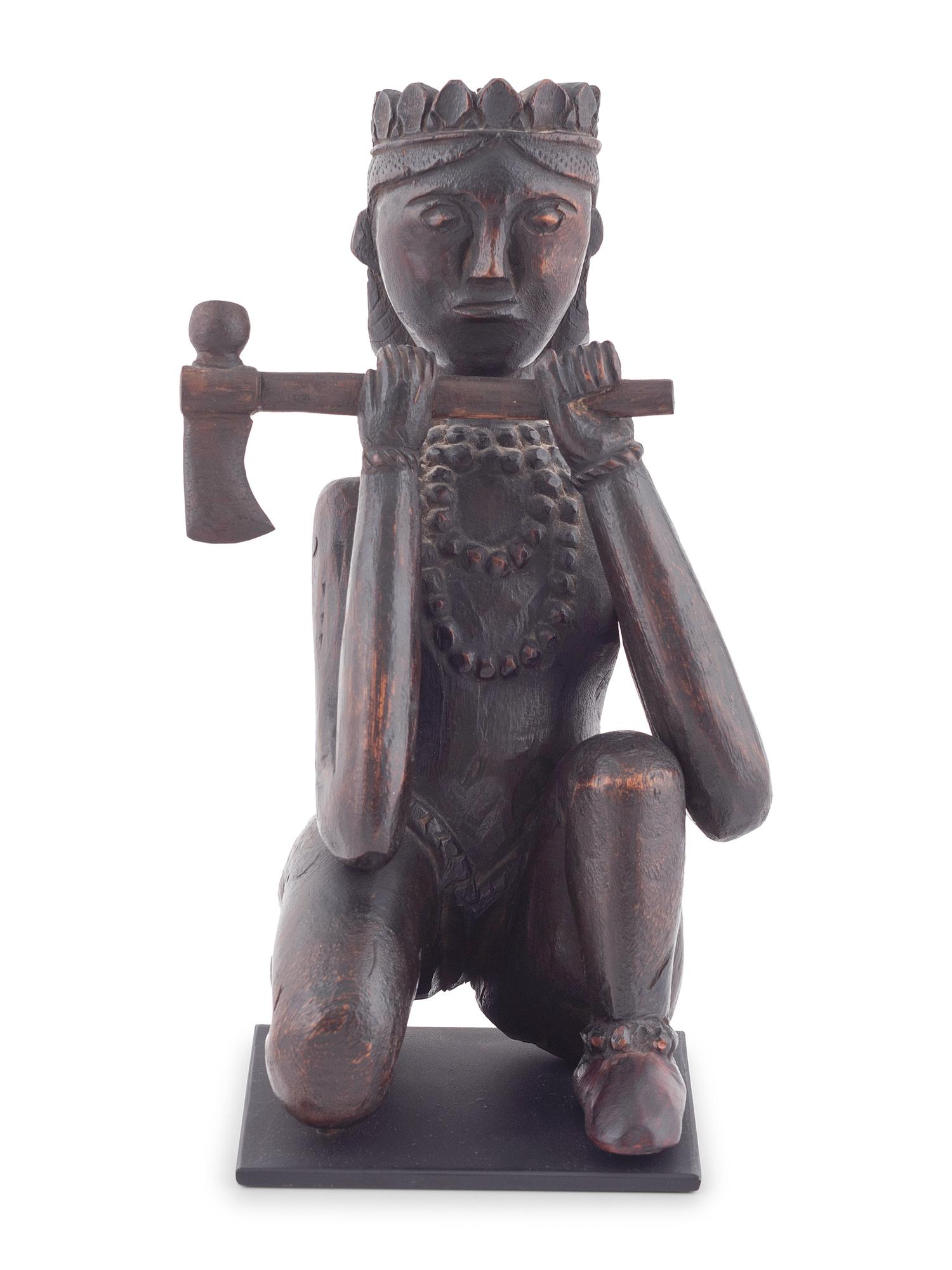 A Seated Folk Art Carved Walnut Indian with Tomahawk