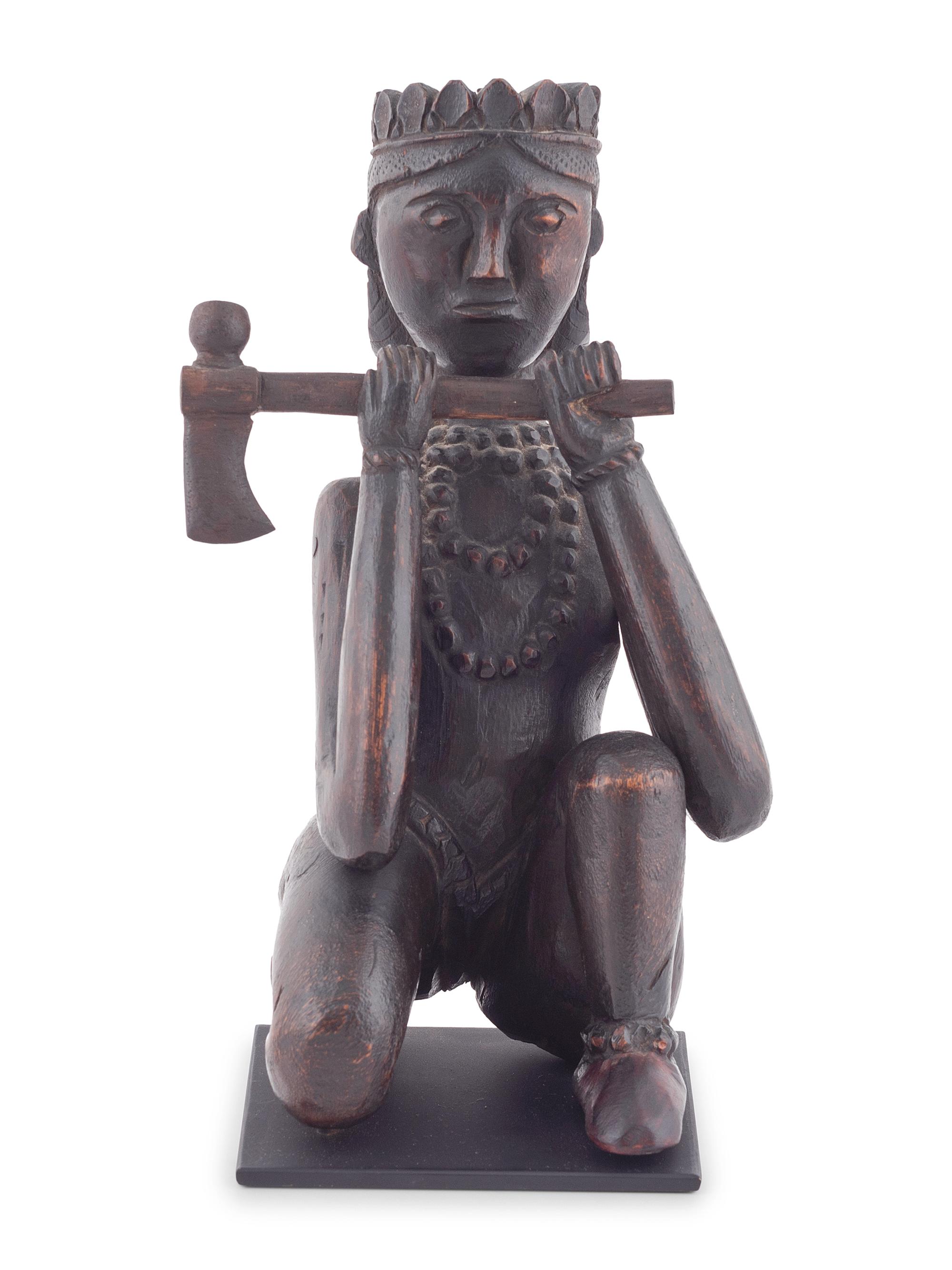 A Seated Folk Art Carved Walnut Indian with Tomahawk