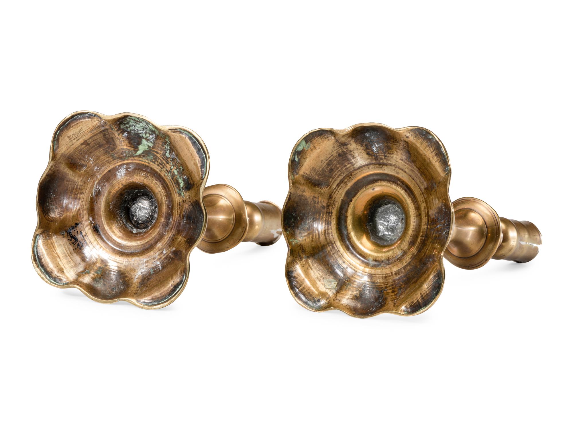 A Pair of English Brass Scalloped-Foot Candlesticks